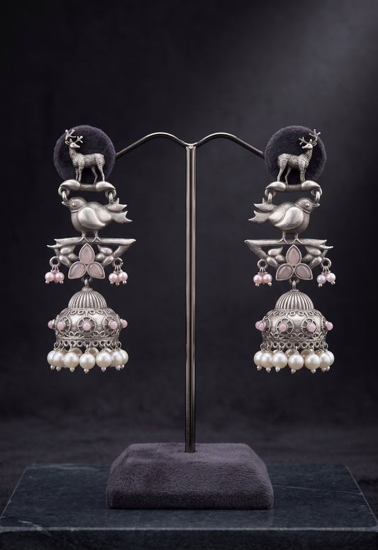 Pair of ornate earrings on a dark background